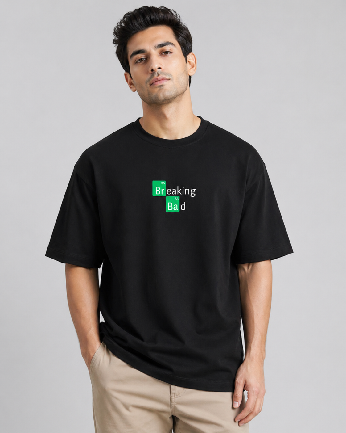 Man wearing a black t-shirt with 'Breaking Bad' logo on a gray background