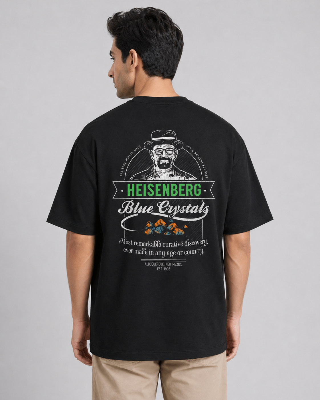 Man wearing a black t-shirt with a graphic design on the back, featuring text and a logo.